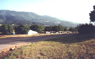 [photo: Classroom tent surrounded with walnut trees]